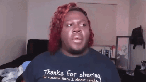a man with red hair wearing a shirt that says thanks for sharing