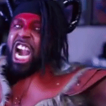 A Man With Red Paint On His Face Is Wearing A Devil Costume GIF