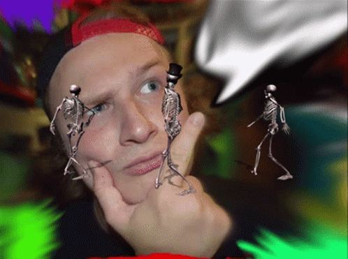 A Man With Skeletons In Front Of His Face And A Top Hat GIF