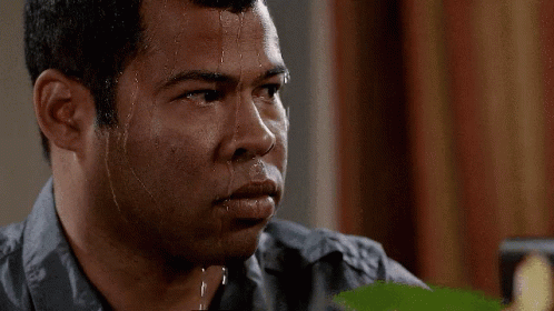 A Man With Sweat Running Down His Face Is Looking Down GIF