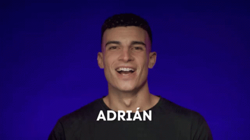 A Man With The Name Adrian On His Shirt Smiles GIF