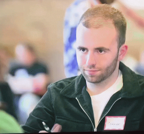 A Man With The Name Connor On His Name Tag GIF