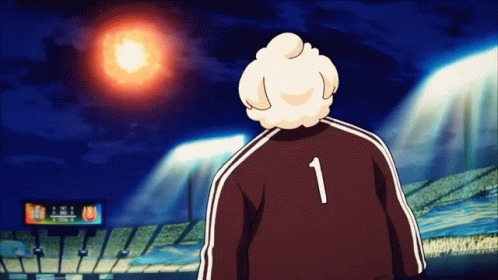 A Man With The Number 1 On His Back Stands In Front Of A Stadium GIF