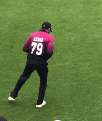 A Man With The Number 79 On His Back Is Standing On One Leg GIF