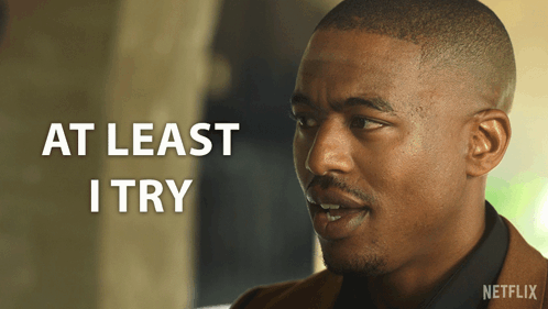 A Man With The Words At Least I Try On The Bottom GIF