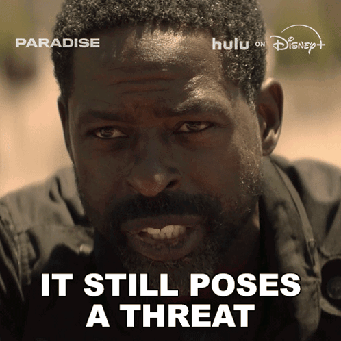 A Man With The Words " It Still Poses A Threat " On The Bottom GIF