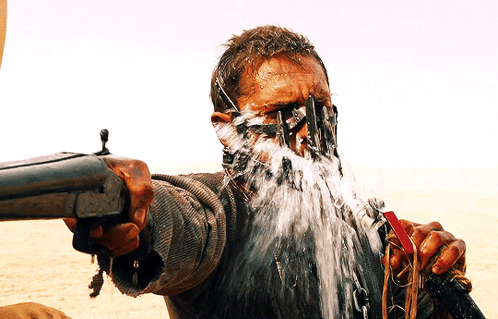A Man With Water Coming Out Of His Mouth And A Gun GIF