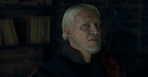 a man with white hair and a beard has the words not bloody likely written below him