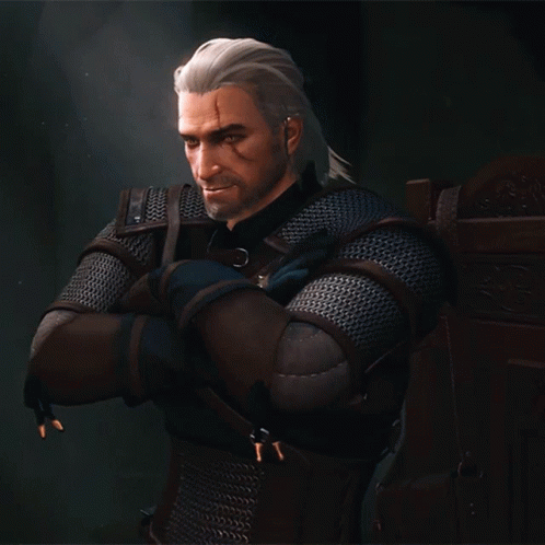 a man with white hair and a beard is wearing a chain mail armor