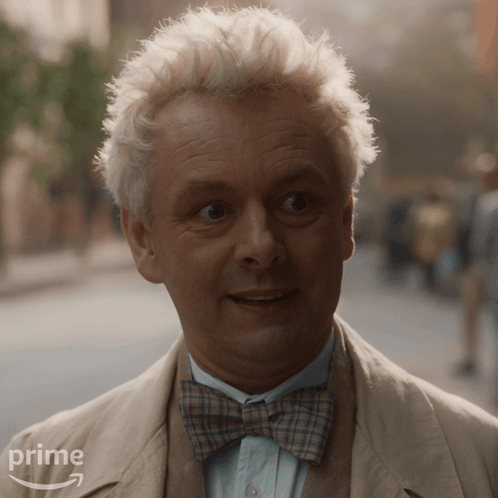 A Man With White Hair And A Bow Tie Is Wearing A Suit And Tie From Prime GIF