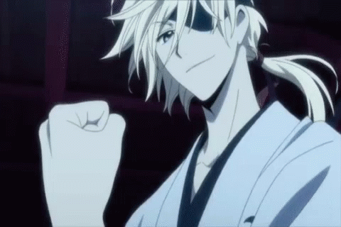 A Man With White Hair And A Ponytail Is Making A Fist In The Air GIF