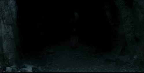 A Man With White Hair Is Holding A Knife In His Hand GIF