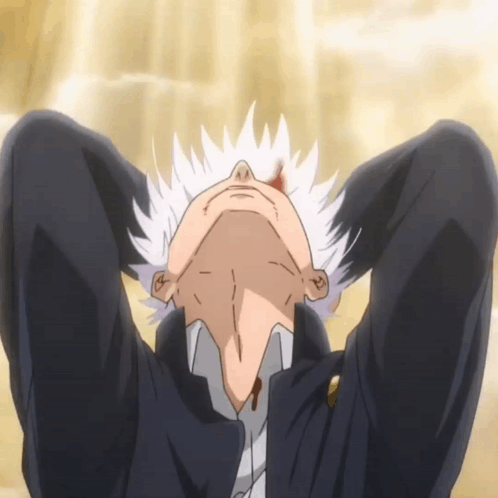 A Man With White Hair Is Laying On The Floor With His Head Down GIF