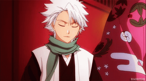 A Man With White Hair Is Wearing A Green Scarf Around His Neck And The Word Bleach Is On The Bottom GIF