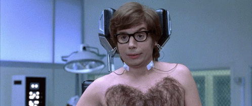 A Man Without A Shirt Has Headphones On His Head GIF