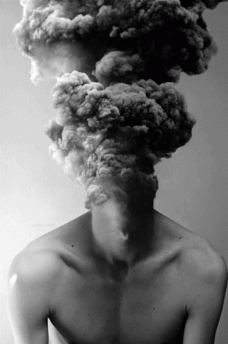 A Man Without A Shirt Has Smoke Coming Out Of His Head .. GIF