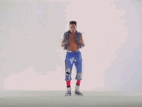 A Man Without A Shirt Is Dancing On A White Surface . GIF
