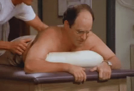 A Man Without A Shirt Is Getting A Massage From Another Man GIF