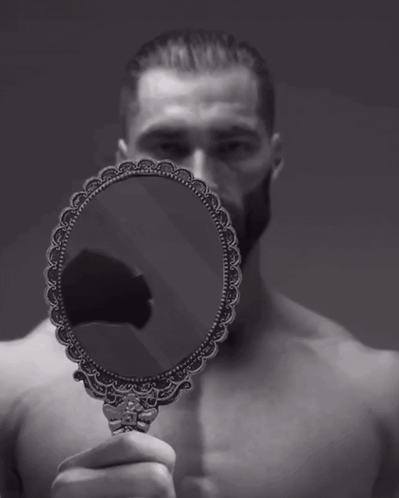 A Man Without A Shirt Is Holding A Small Mirror In Front Of His Face GIF