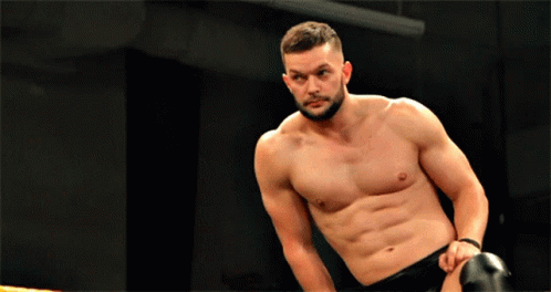 A Man Without A Shirt Is Kneeling Down In A Boxing Ring GIF