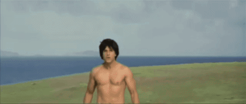 a man without a shirt is looking at the camera