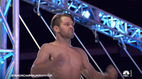 A Man Without A Shirt Is On A Nbc Show Called American Ninja Warrior GIF