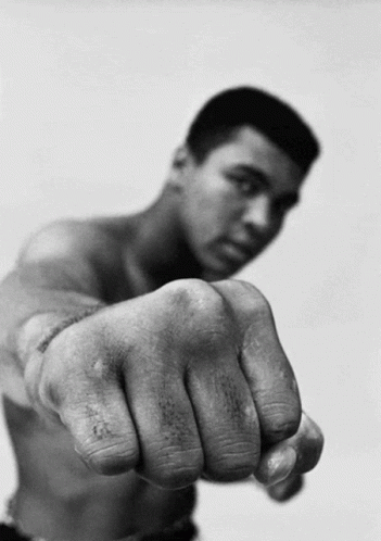 A Man Without A Shirt Is Pointing His Fist GIF