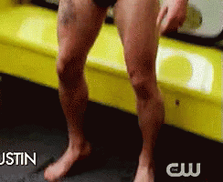 A Man Without A Shirt Is Sitting On A Yellow Couch With The Words Justin Behind Him GIF