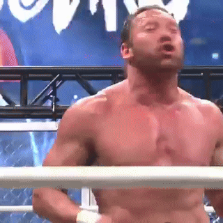 a man without a shirt is standing in a boxing ring with his eyes closed