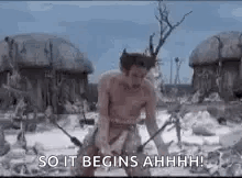 A Man Without A Shirt Is Standing In A Field With A Sword In His Hand . GIF