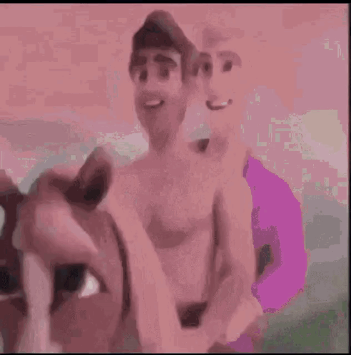 A Man Without A Shirt Is Standing In Front Of A Green Car . GIF