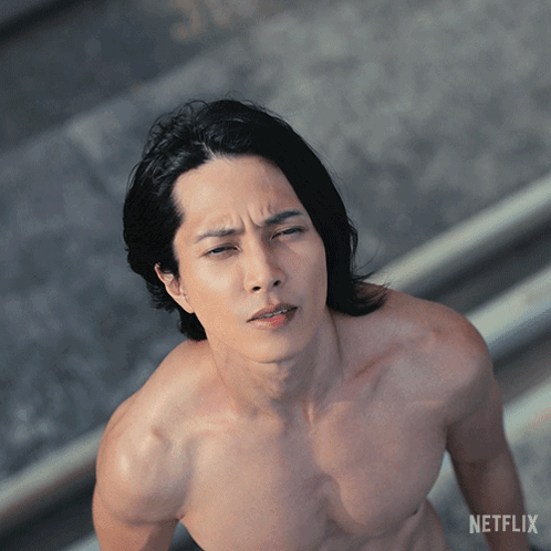 A Man Without A Shirt Is Standing In Front Of A Netflix Logo GIF