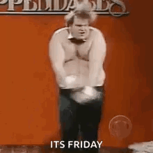 A Man Without A Shirt Is Standing In Front Of A Red Wall . GIF