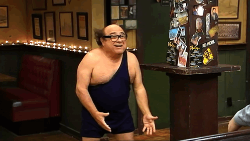 A Man Without A Shirt Is Standing In Front Of A Sign That Says ' Ad Here ' GIF