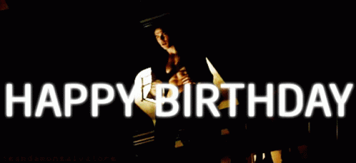 A Man Without A Shirt Is Standing In Front Of A Sign That Says " Happy Birthday " GIF