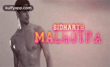 A Man Without A Shirt Is Standing In Front Of A Sign That Says Siddharth Malhotra GIF