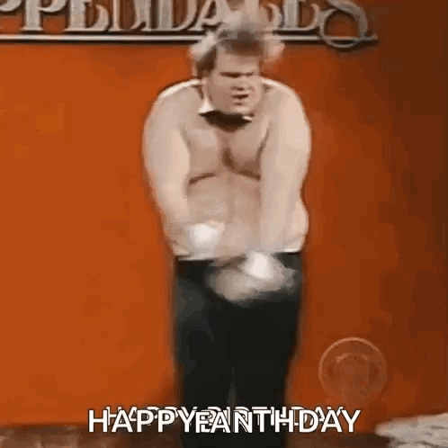 A Man Without A Shirt Is Standing In Front Of An Orange Wall And Says Happy Earth Day . GIF