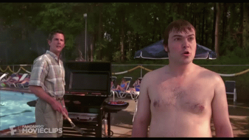 A Man Without A Shirt Is Standing Next To A Man Cooking On A Grill In Front Of A Swimming Pool GIF