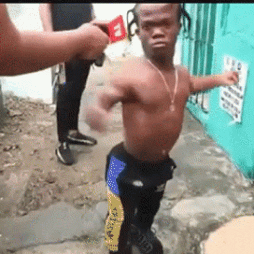 A Man Without A Shirt Is Standing On A Sidewalk In Front Of A Sign That Says ' A ' On It GIF