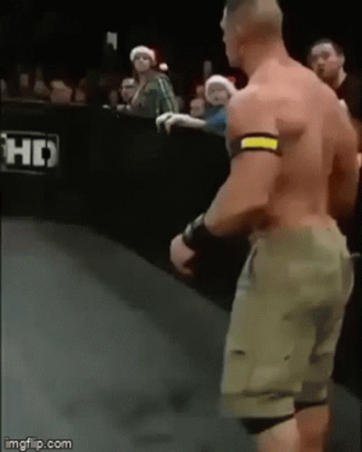 A Man Without A Shirt Is Standing On A Wrestling Ring . GIF