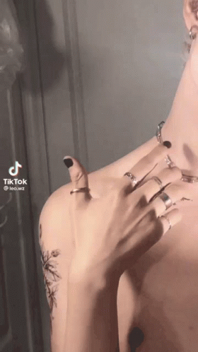 A Man Without A Shirt Is Wearing A Lot Of Rings On His Fingers GIF