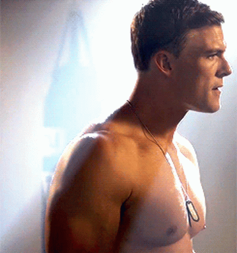 A Man Without A Shirt Is Wearing A Necklace With The Number 10 On It GIF