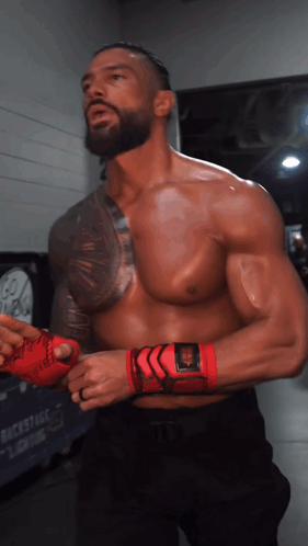 A Man Without A Shirt Is Wearing A Pair Of Red Gloves GIF
