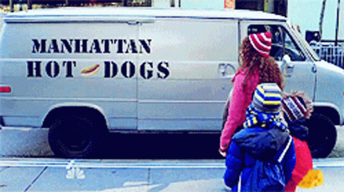 A Manhattan Hot Dog Van Is Parked On The Street GIF
