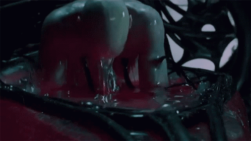 A Mannequin Is Covered In Red Liquid And Crawling Through A Hole In The Floor GIF