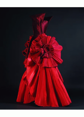 A Mannequin Wearing A Red Dress With Ruffles On The Sleeves GIF