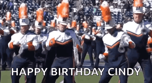 a marching band is dancing on a field with the words happy birthday cindy in the background .
