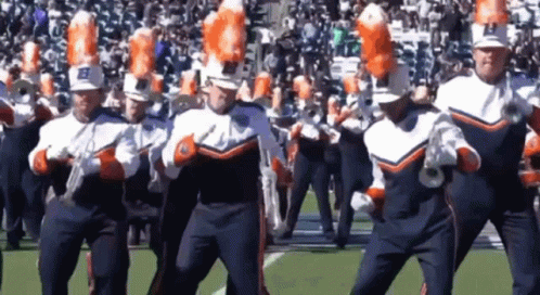 A Marching Band With The Letter B On Their Hats Is Performing On A Field GIF