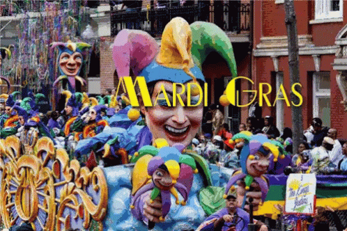 A Mardi Gras Parade With A Large Jester Float In The Foreground GIF