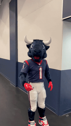 A Mascot Dressed As A Bull Wearing A Jersey With The Number 1 On It GIF